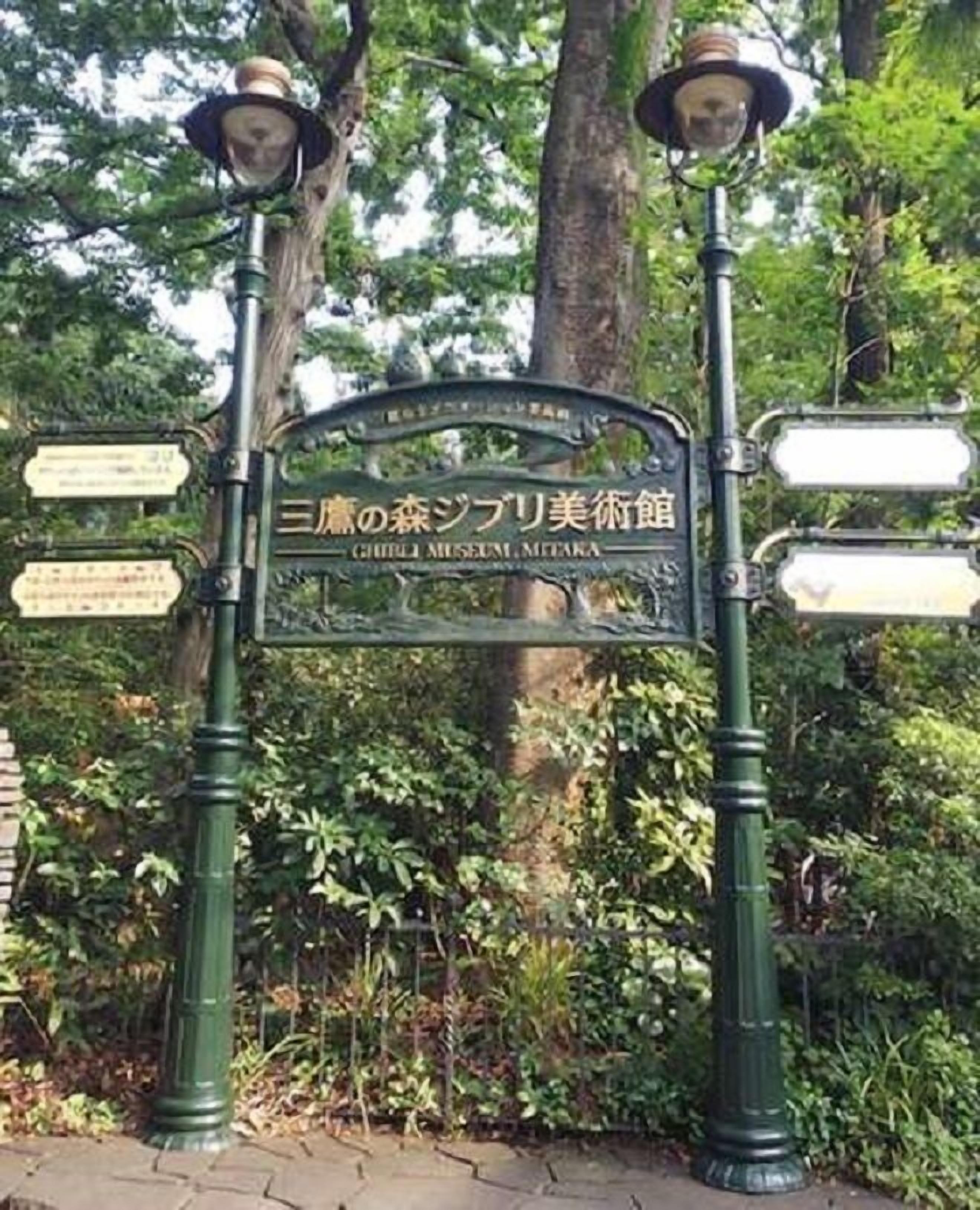 A signpost with multiple directional signs and a lamp post.