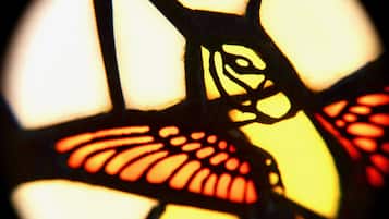 A close-up of a stained glass window with geometric patterns.