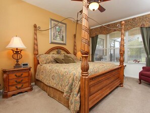 A four-poster bed with a canopy, a bedside table with a lamp, a dresser, and a window with curtains. - Ov3776 - Windsor Hills Resort - 5 Bed 5 Baths Villa (Kissimmee)