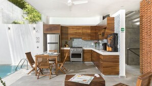 A modern kitchen with wooden cabinets, a stainless steel refrigerator, and a gas stove. - Steps from the Beach Luxury Suite w/Private Pool (San Francisco)