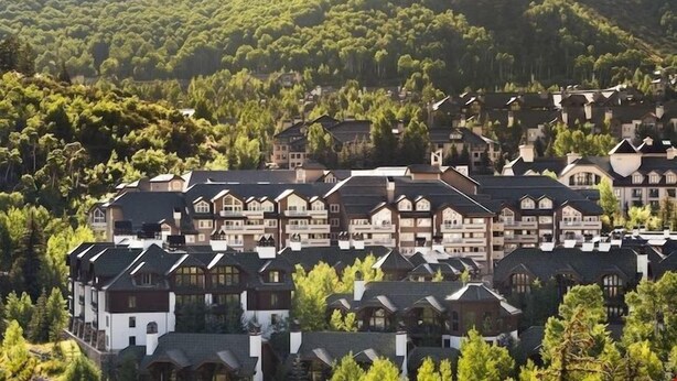 A residential area with multiple two-story houses, surrounded by dense forest. - Premium Condo with Modern Finishings (Beaver Creek)