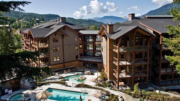 A multi-story lodge with a pool area, surrounded by mountains. - Spacious + Modern Suite | Minutes from Whistler (Whistler)