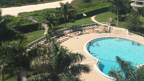 A resort pool with a view of the ocean and a beach. - Stunning Beachfront Condo in Gated Community (Marco Island)