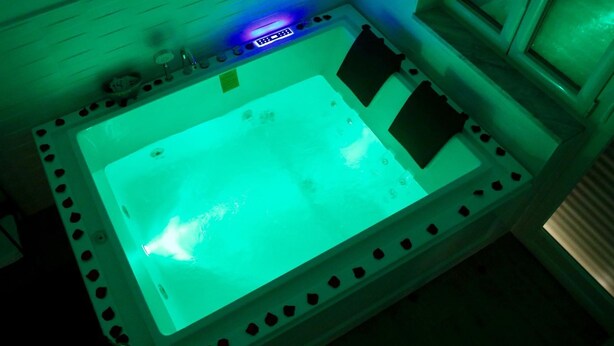 A large, rectangular hot tub with a digital control panel and a green light. - Affittacamere Andolfi 24 (Pompei)