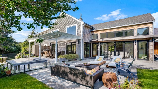 A modern house with a patio area featuring outdoor furniture, a pergola, and a fire pit. - Modern 6Bed-6Bath New in 2023! (Edgartown)