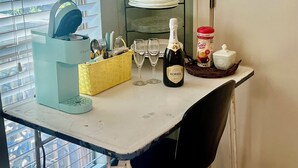 A kitchen counter with a bottle of Korbel Brut, a coffee maker, and a fruit basket. - PERFECT COUPLES GET AWAY IN THE HEART OF DOWNTOWN BOERNE!! (Boerne)