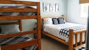 A room with a bunk bed, a single bed, and three framed deer head pictures on the wall. - Spacious Mountain Retreat, great for groups & families (Arnold)