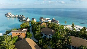 A resort with overwater bungalows, a beach, and lush greenery. - SAii Lagoon Maldives, Curio Collection by Hilton (Eh'mafushi)