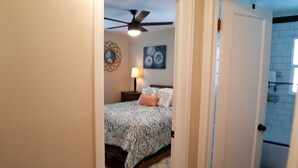 A bedroom with a bed, a ceiling fan, a nightstand, and wall art. - NEW! Walk to Old Littleton and light rail from this lovely home w/private yard (Littleton)