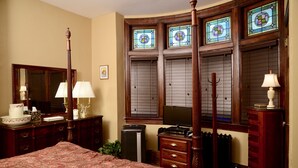 A bedroom with a four-poster bed, wooden dresser, and a large mirror. - Beautiful 2BR Apt. /Pittsburgh/East/Regent Square/Frick Park (Pittsburgh)