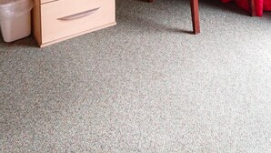 A small, neatly arranged room with a wooden desk, a chair, a laptop, a kettle, and a trash bin. - Wellington Hotel (Goole)