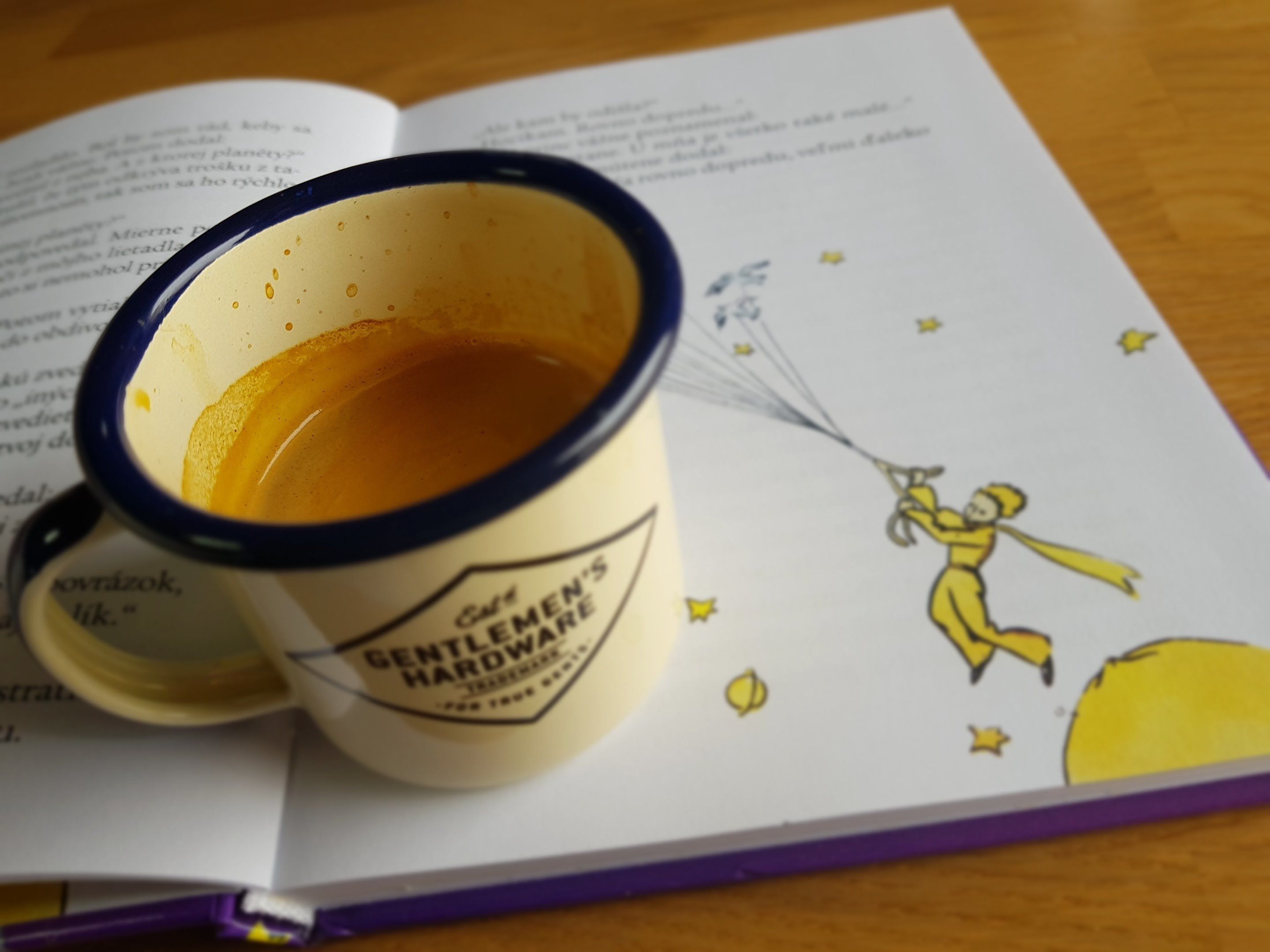 A book with a coffee mug on top.