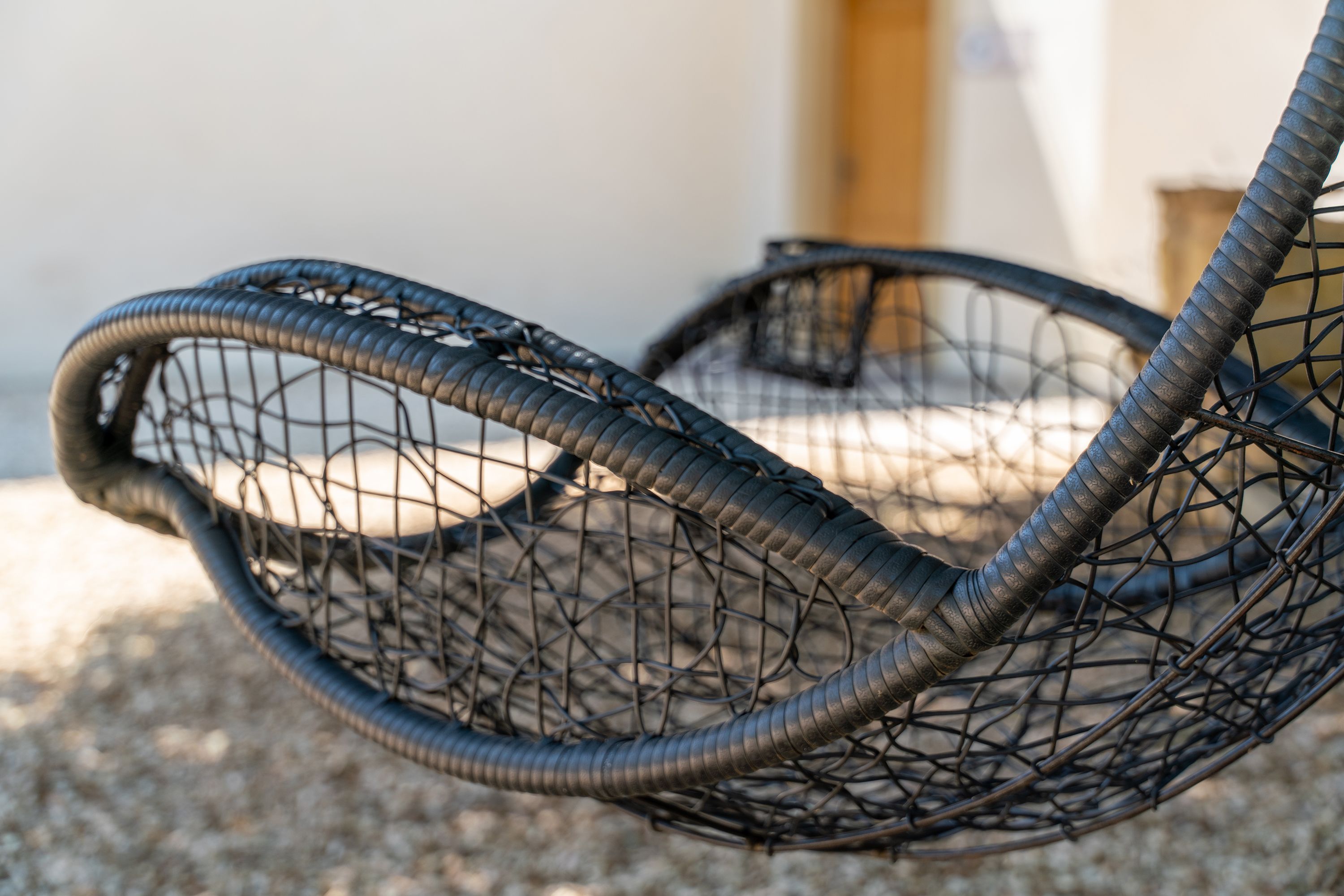 A close-up of a woven chair with a curved design.