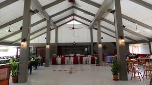 A spacious indoor area with high ceilings, a central serving counter, and multiple seating arrangements. - Lemonia Holiday Resort (Langkawi)