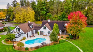 A residential property with a swimming pool, a covered patio, and a well-maintained lawn. - The Morris Estate (Niles)