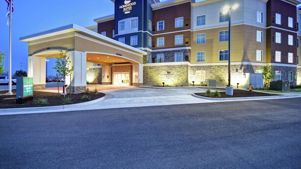 A multi-story hotel with a modern design, featuring a prominent entrance with a covered walkway and a flagpole. - Homewood Suites by Hilton Salt Lake City Airport (Salt Lake City)
