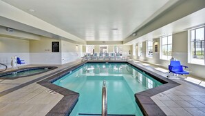 An indoor swimming pool with clear lanes, blue chairs, and a tiled floor. - Homewood Suites by Hilton Salt Lake City Airport (Salt Lake City)