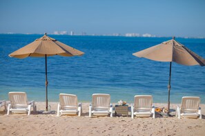 On the beach, sun-loungers, beach towels