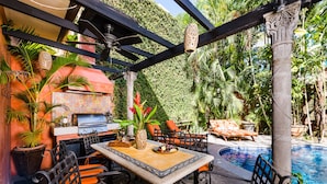 An outdoor patio with a grill, seating, and a pool. -  Villa Oasis: A luxury villa just steps to beach with private pool, WIFI & A/C  (Tamarindo)