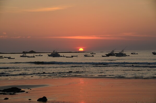 A beach with boats and a sunset. - Villa Oasis: A luxury villa just steps to beach with private pool, WIFI & A/C (Tamarindo)