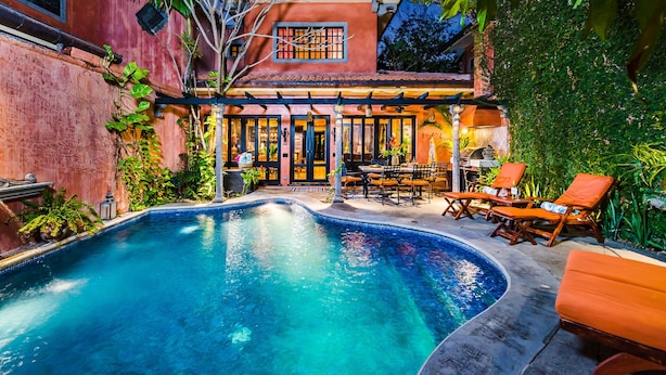 A swimming pool with a patio area, a dining table, and chairs. -  Villa Oasis: A luxury villa just steps to beach with private pool, WIFI & A/C  (Tamarindo)