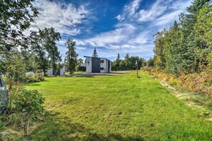 Situated in a lush landscape, this two-story building offers a serene setting with a well-maintained lawn and trees.
