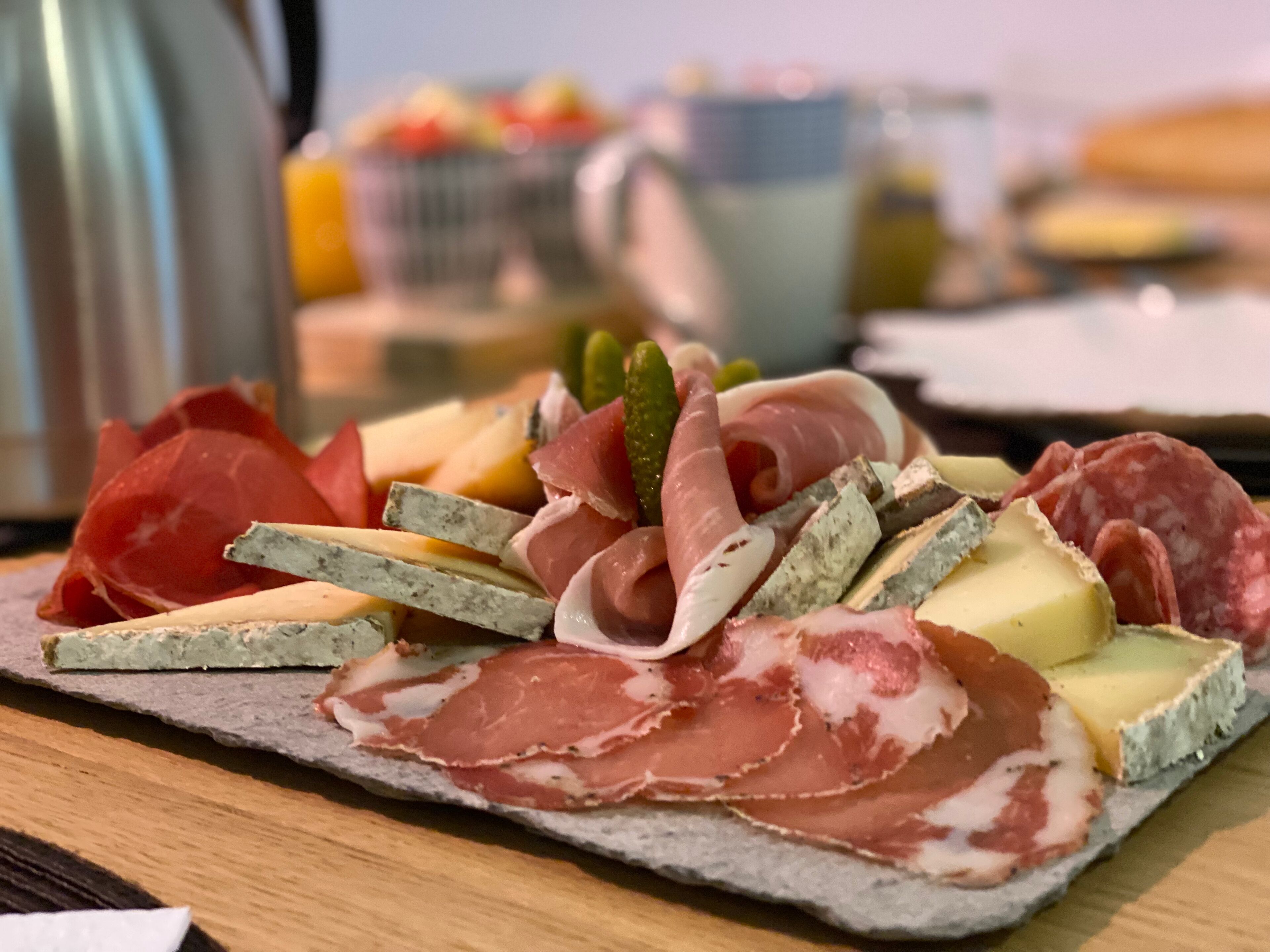 A charcuterie board with various meats and cheeses.