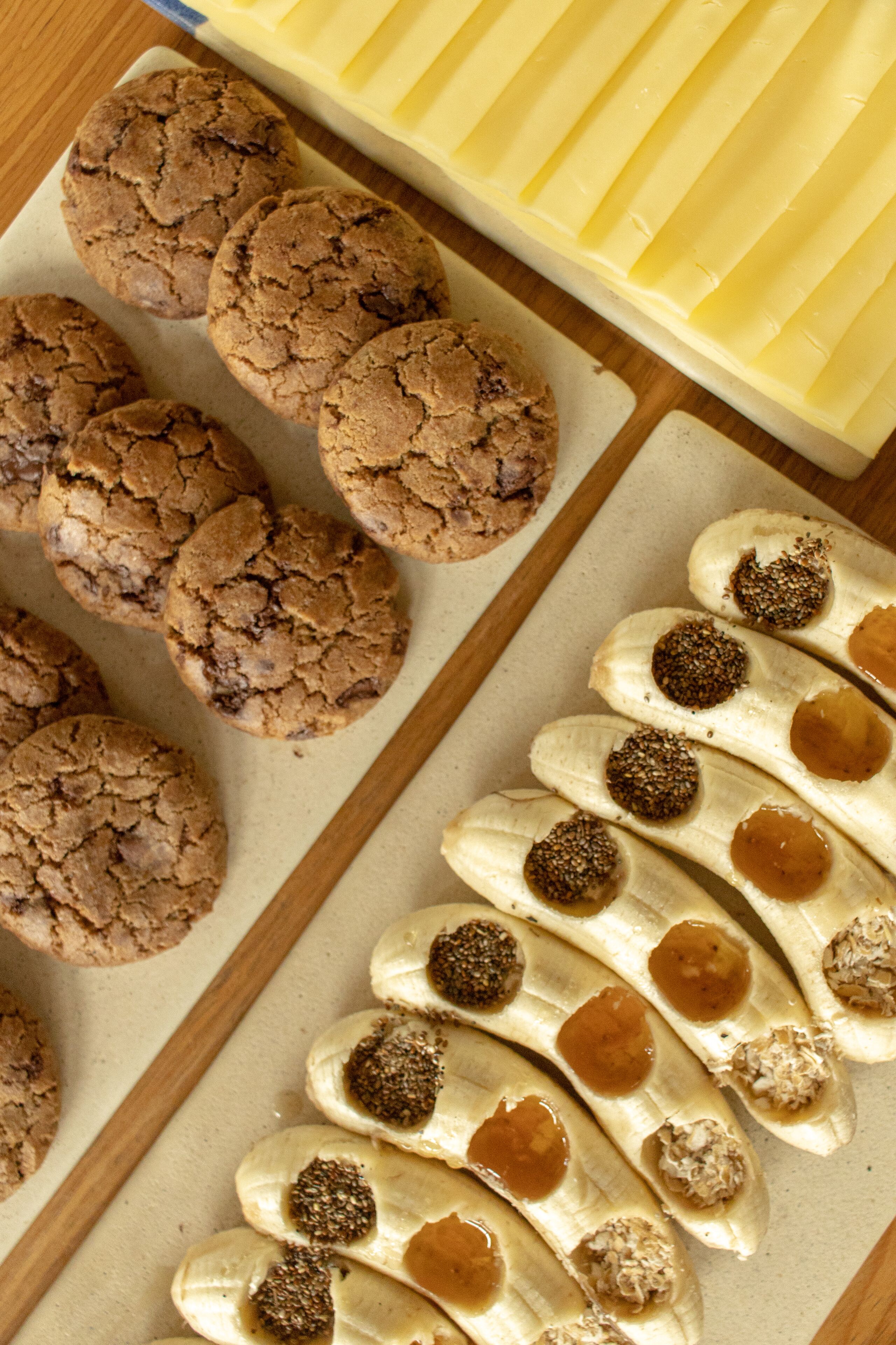 A tray of cookies and banana slices with toppings.
