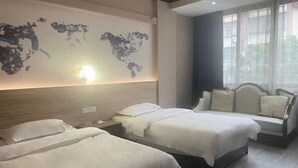 A hotel room with two beds, a world map mural, a sofa, and a window with curtains. - Cang Long Hotel (Hezhou)