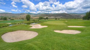 A golf course with bunkers, water hazards, and a mountainous backdrop. - Fireplace & Private Balcony | Pool & Hot Tub (Edwards)