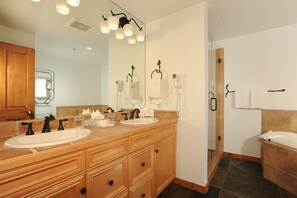 A bathroom with two sinks, a large mirror, and a shower area. - Ski-In/Ski-Out Condo Pool, Hot Tub, BBQ + Fire Pit (Dillon)
