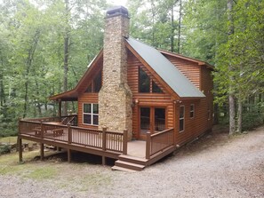 A log cabin with a stone chimney, wooden deck, and large windows. - Kays Kabin Appalachian Trail (Suches)