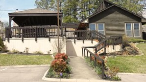 A two-story house with a covered porch and a fenced yard. - "AMAZING" LONG RANGE MOUNTAIN VEIWS!! Peaceful MountainTop Getaway! (Gatlinburg)