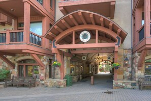 Arrowhead Alpine Club's distinctive entrance features a curved overhang, stone pillars, and a circular emblem.