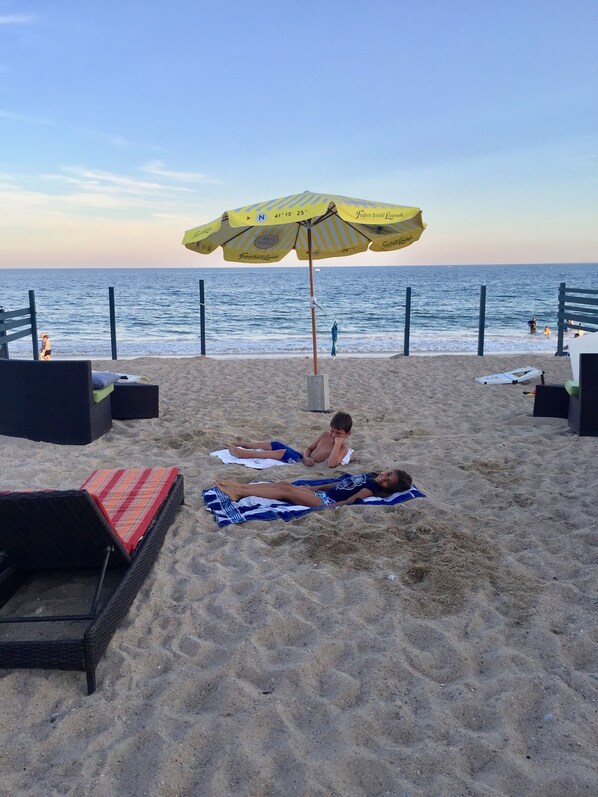A beach with a yellow umbrella, lounge chairs, and a view of the ocean. - Amazing Ocean Front 2 Story Home, Steps Away From The Water (Westerly)