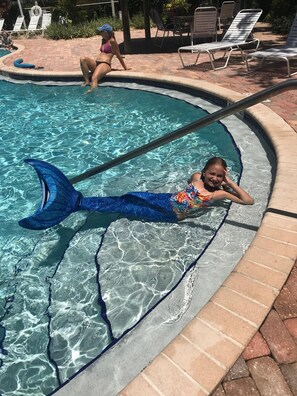 A swimming pool with clear water, lounge chairs, and a tiled deck. -  Casa Calypso- Beautiful Tropical 3 KING Beds, 3 baths - 2 miles to beach (Key West)