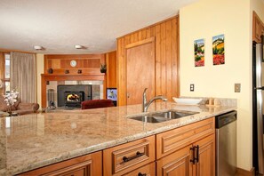 Enjoy cooking in this well-equipped kitchen with a stove, granite countertop, and ample cabinetry.