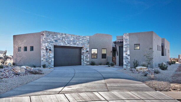 A modern house with a stone facade, a garage, and a landscaped driveway. - Fish Rock Retreat Holiday home 3 (St. George)