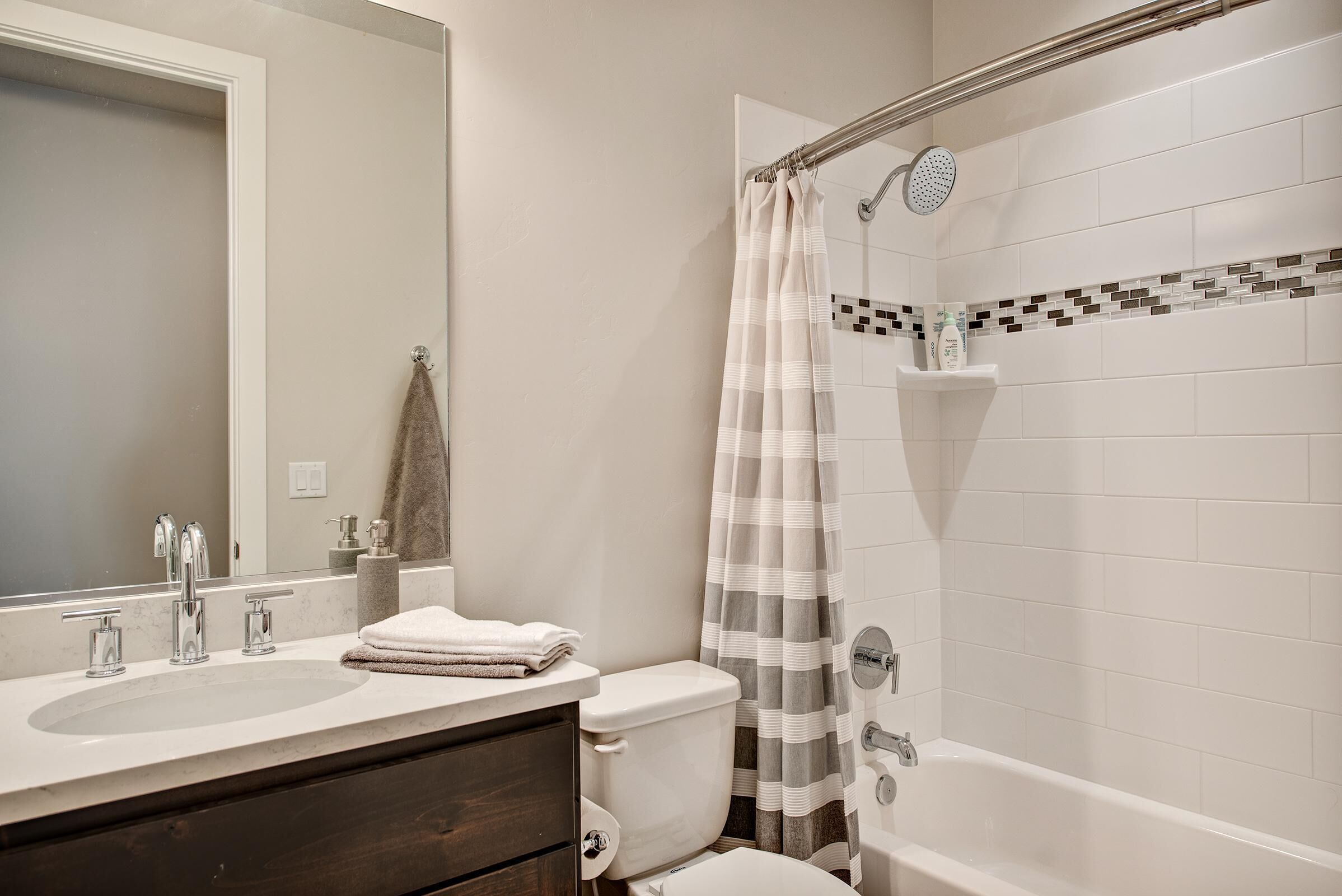 A bathroom with a sink, toilet, and bathtub.