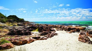 A rocky beach with clear turquoise water and a clear sky. - Superb Dual Keyed Home with Stunning Ocean Views just 300 Metres to Beach (Dunsborough)