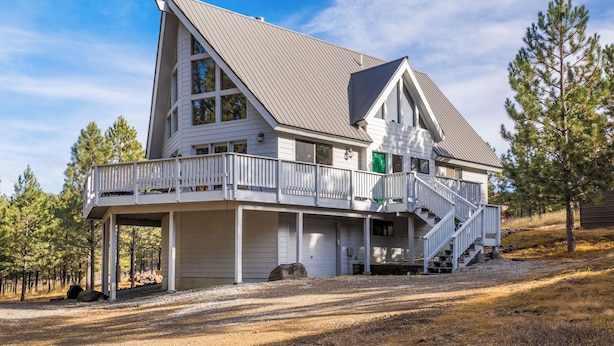 A two-story house with a balcony and a staircase leading to the upper floor. - Newly Updated Mtn House! Walk to Golf/Tennis/Park, Hot Tub, Firepit, Ping Pong (Angel Fire)