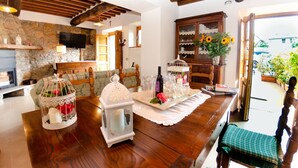 A cozy living room with a stone fireplace, wooden furniture, and a view of the outdoors. - Wonderful private villa with private pool, internet, A/C, TV, terrace, pets allowed, close to Lucca (Palmata)