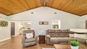 A spacious living room with a high wooden ceiling, a 'HOME' sign on the wall, and a dining area in the background. - 3/2 NEWLY REMODELED HOME IN CRYSTAL RIVER! Bring your boat and RV/Camper!  (Crystal River)