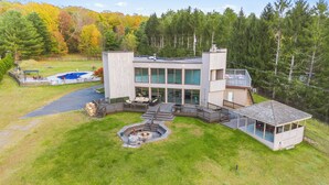 Uma casa moderna de dois andares com varanda, banheira de hidromassagem e lareira.