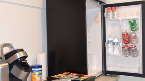 A kitchen with a built-in refrigerator containing beverages and snacks, a coffee machine, and a paper towel dispenser. - West Racquet Club Art Hall (Palm Springs)