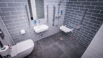A modern bathroom with a toilet, sink, and shower.