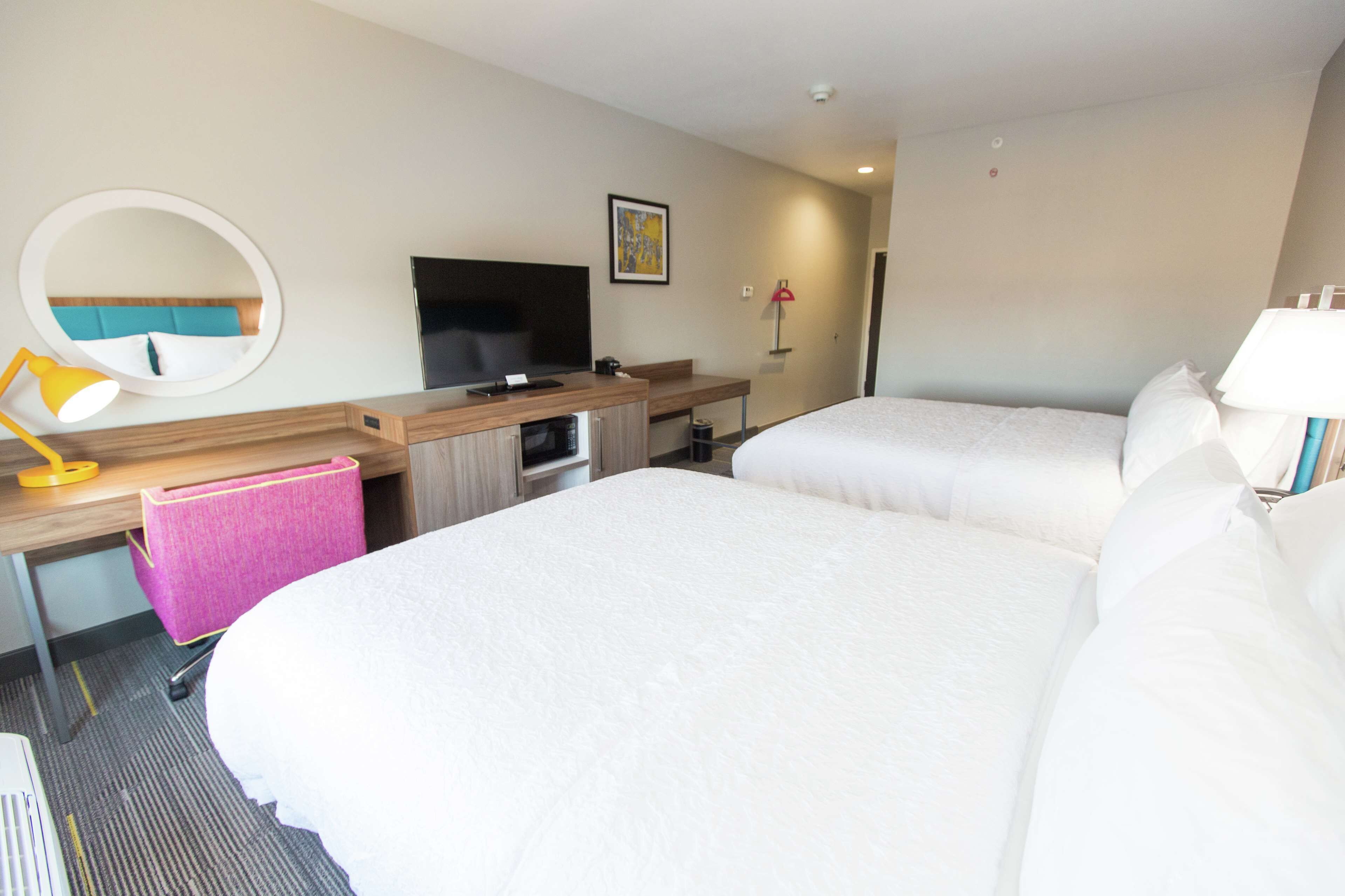 room, 2 queen beds, refrigerator & microwave | in-room safe, blackout curtains, cots/infant beds, free wifi