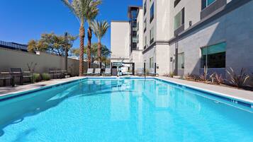 Outdoor pool, open 6:00 AM to 10:00 PM, pool loungers