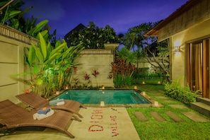 A pool area with lounge chairs and a pathway marked with 'MOANA'. - Villa Dion (Canggu)