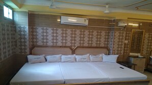 Una cama grande con cabecera de madera y varios almohadones, con la etiqueta "S.S.K. Residency".
